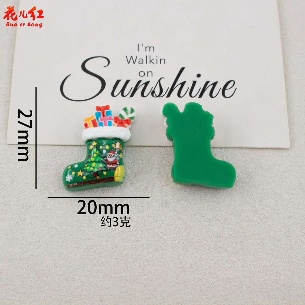 Green resin boot cabochon with red and white Christmas decorations and a green silhouette of a boot