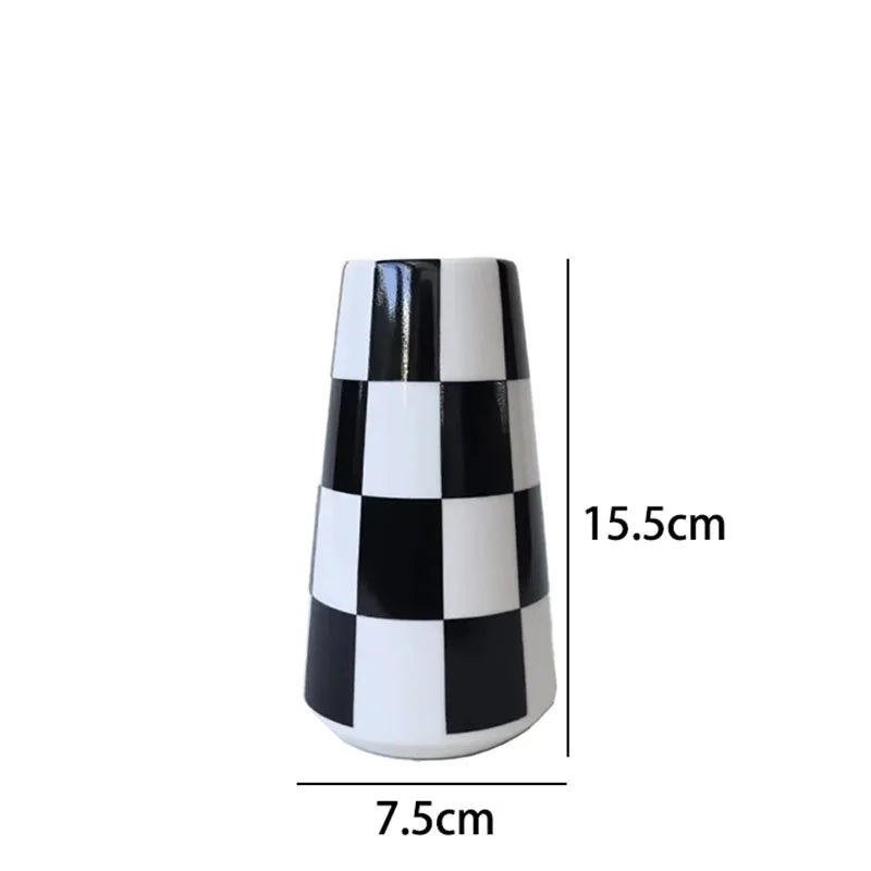 A ceramic tabletop vase with a black and white checkered pattern, shown from the side.
