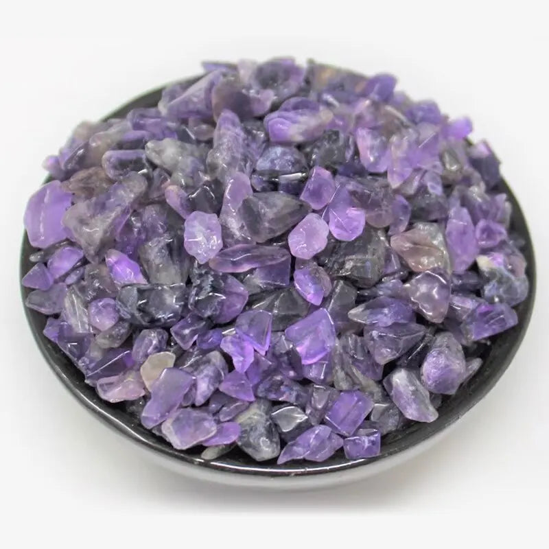 A pile of purple amethyst gemstone chips for crafts and jewelry making.