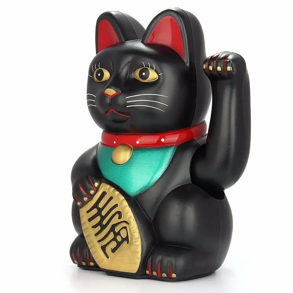 A black figurine of a cat with red ears, wearing a red collar and gold accents.