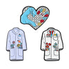 Set of enamel pins featuring a rude middle finger and daisy flower designs