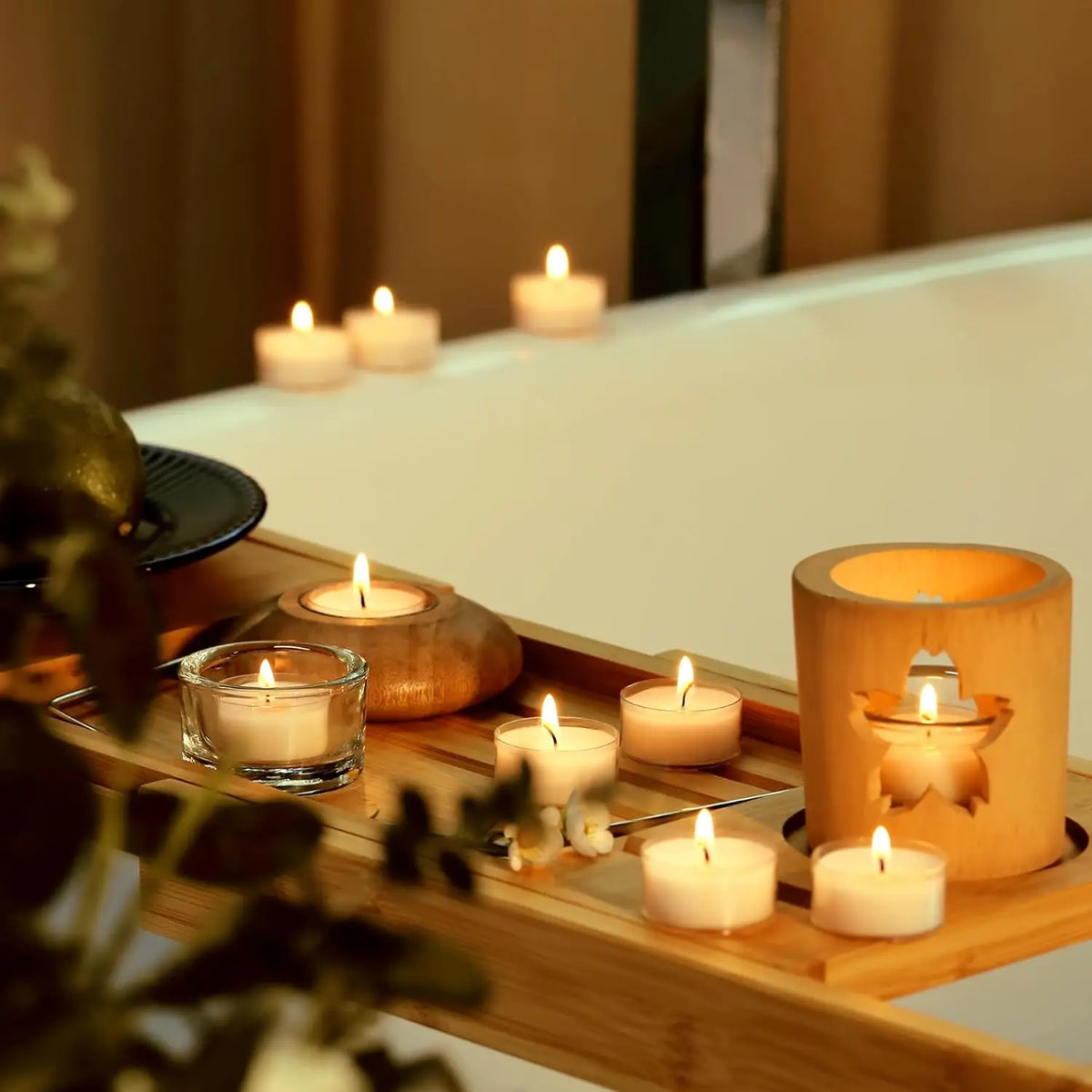 A wooden tray holds several natural beeswax tealight candles lit, creating a warm ambiance.