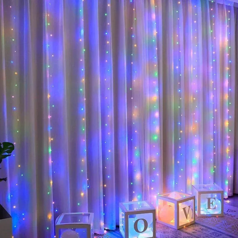 Purple and pink LED curtain fairy lights illuminating a sheer fabric backdrop.