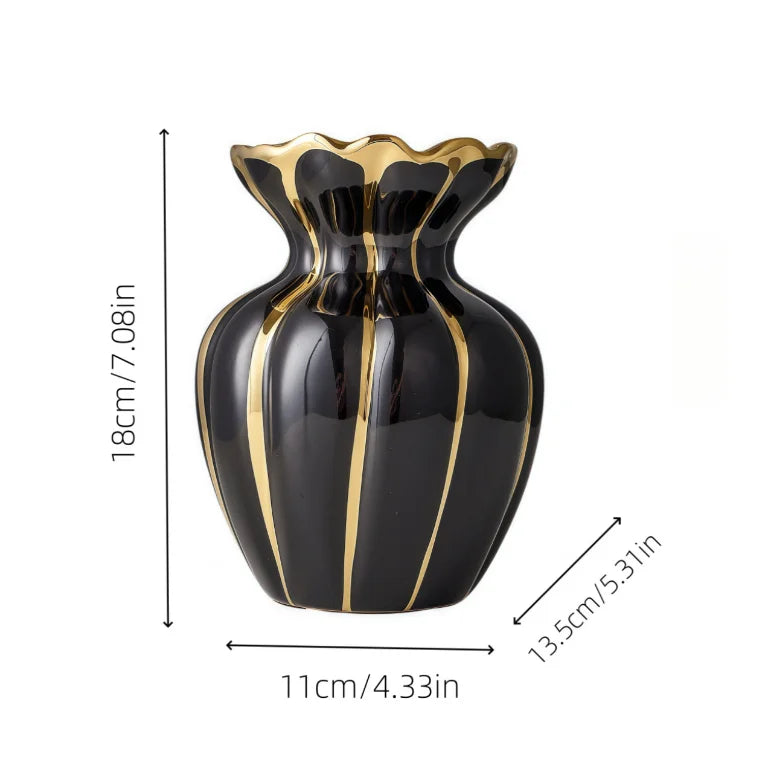A black ceramic flower vase with gold accents and vertical stripes, shown from the side.