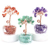 Three crystal healing gemstone bonsai trees featuring pink, green, and purple stones on wooden branches.
