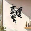 Black metal wall art of an elegant butterfly and floral design on a white wall.