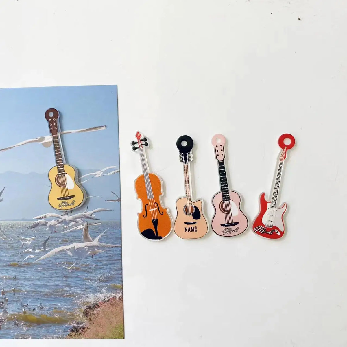 A set of five guitar-shaped fridge magnets in various colors and finishes for music lovers.