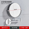 A round folding double-sided wall mirror with a 20cm diameter and telescopic arms mounted on a gray wall.