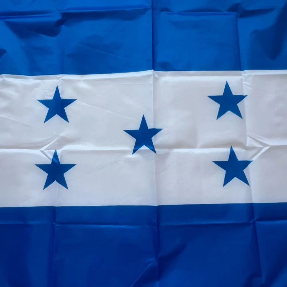 A folded blue and white flag of Honduras with five blue stars on a white stripe.
