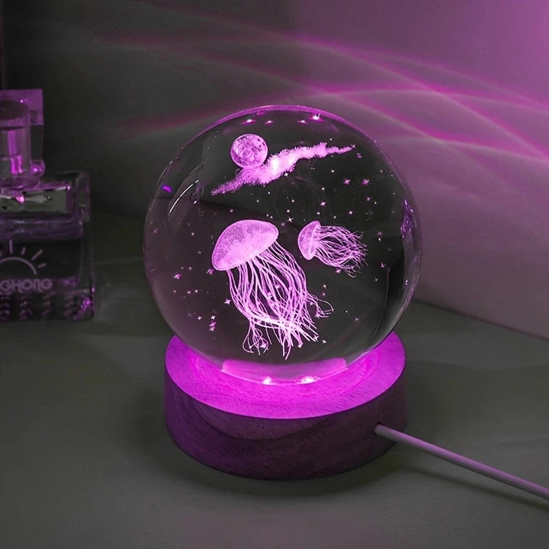 A crystal ball night light featuring glowing purple light and an image of a jellyfish inside.