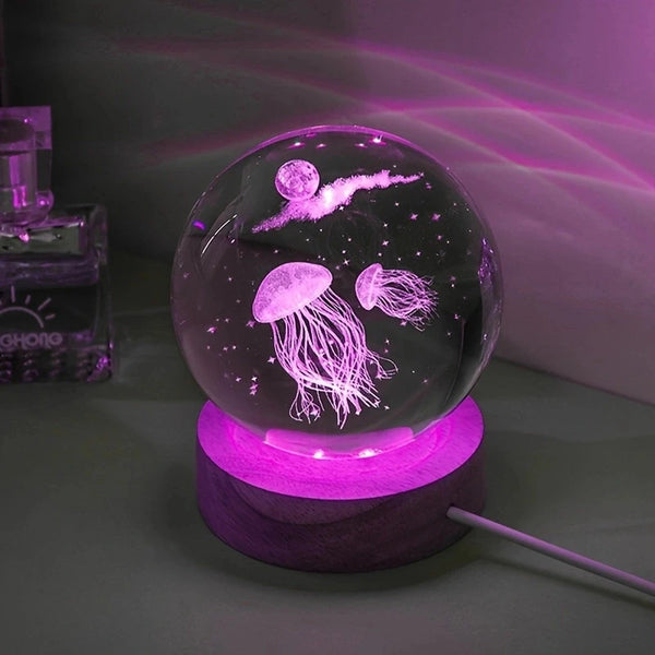 A crystal ball night light featuring glowing purple light and an image of a jellyfish inside.