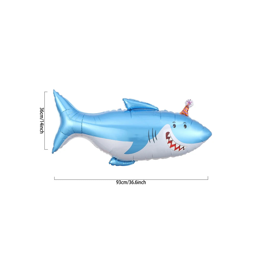A blue foil balloon shaped like a shark with an open mouth and a small orange decoration.