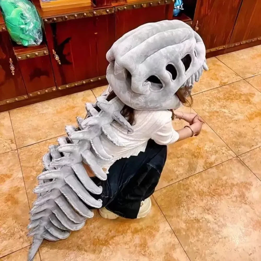 Un disfraz de peluche que parece un esqueleto de dinosaurio con grandes dientes y una espina larga y texturizada.