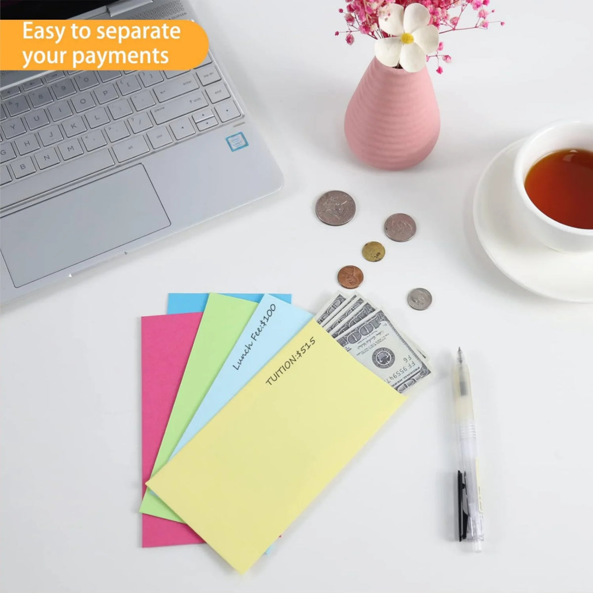 Colorful side-loading cash envelopes for budgeting and saving placed on a white surface next to a laptop.