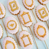 Four pink silicone frame molds with gold accents for chocolate, clay, and crafts