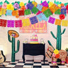 Colorful papel picado banners in various colors decorate a wall with a cactus and a dresser.