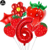 A set of red strawberry shaped balloons and a large red number six balloon for a party kit