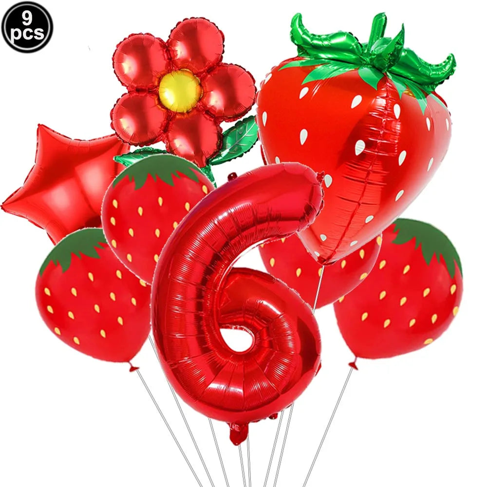 A set of red strawberry shaped balloons and a large red number six balloon for a party kit