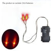 A set of glowing yellow LED eyes for decoration, shown with wires and a timer switch.