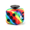 A colorful fidget cube with a rainbow design and a black top, used as a stress relief toy.