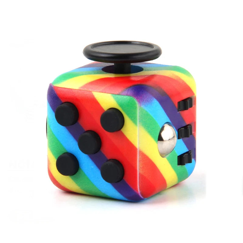 A colorful fidget cube with a rainbow design and a black top, used as a stress relief toy.