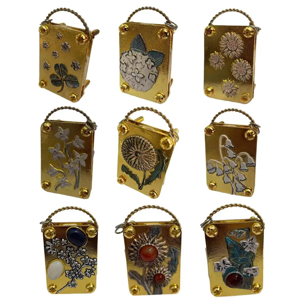 A collection of small metal flower press kits featuring various dried flowers and botanicals.