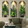 Three framed botanical prints featuring potted tropical plants and vines on a neutral wall.