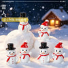 A collection of white resin snowman figurines with red hats and scarves are displayed on a snowy surface.