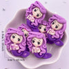 A collection of purple resin mermaid princess figurines with long hair and delicate hands displayed in a pink bowl.