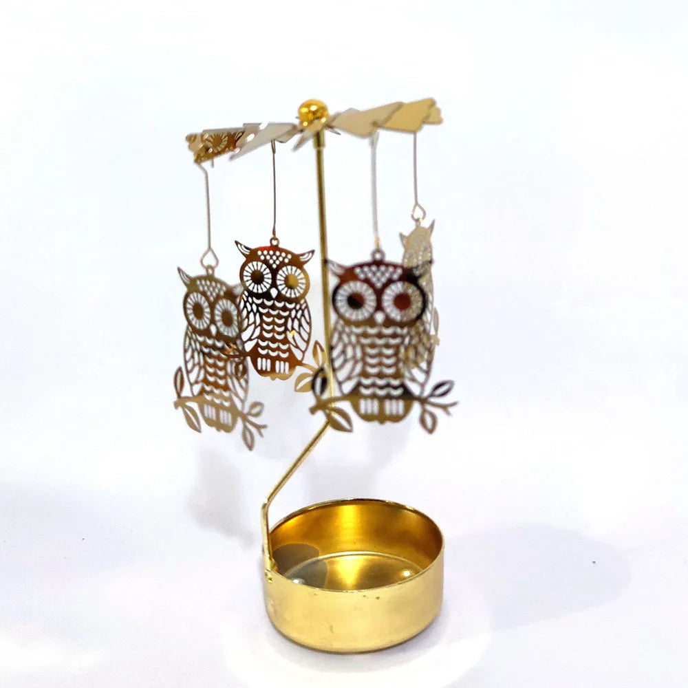 Gold rotating candle holder with a carousel of owl-shaped tealight holders.