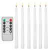 A set of white flameless LED taper candles with a remote control for timer and light functions.