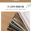 A stack of handcrafted wooden photo frames with various colors and finishes displayed on a wooden surface.