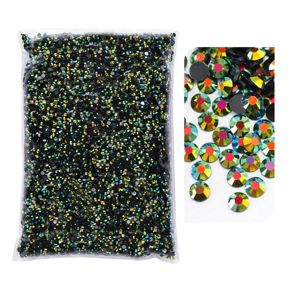 A clear plastic bag filled with black glitter and various colored resin rhinestones.