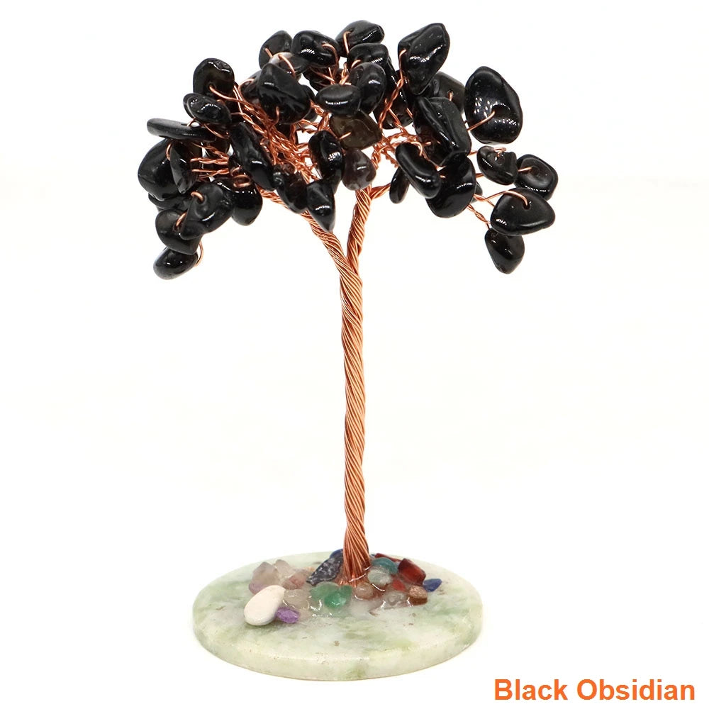 A natural crystal money tree decor featuring black obsidian leaves on a copper wire stem and light green base.