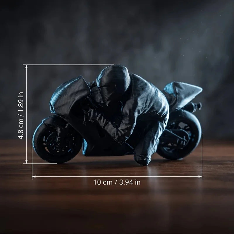 A black 3D printed racing motorcycle rider figurine displayed on a wooden surface.