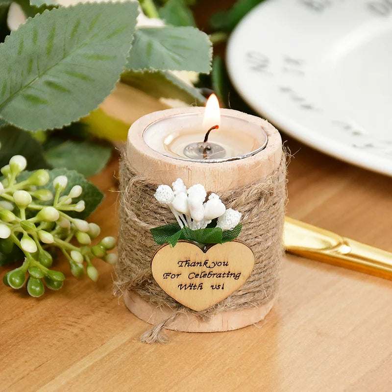 A wooden tealight candle holder wrapped in twine with a small wooden tag that reads Thank you for celebrating with us