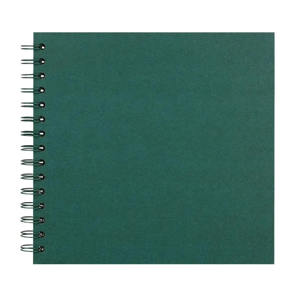 A green spiral-bound notebook or scrapbook album with a dark teal cover.