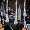 A dark background features a white spider web decoration with light-up eggs and a ghostly figure.