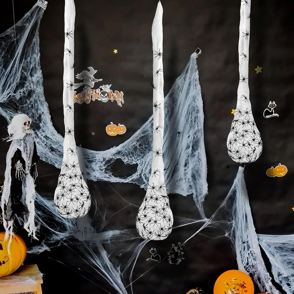 A dark background features a white spider web decoration with light-up eggs and a ghostly figure.
