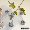 Artificial chrysanthemum pompon flowers on branches used for autumn decor