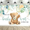 A photo backdrop featuring a cute cartoon teddy bear surrounded by watercolor greenery and light balloons for a baby shower.
