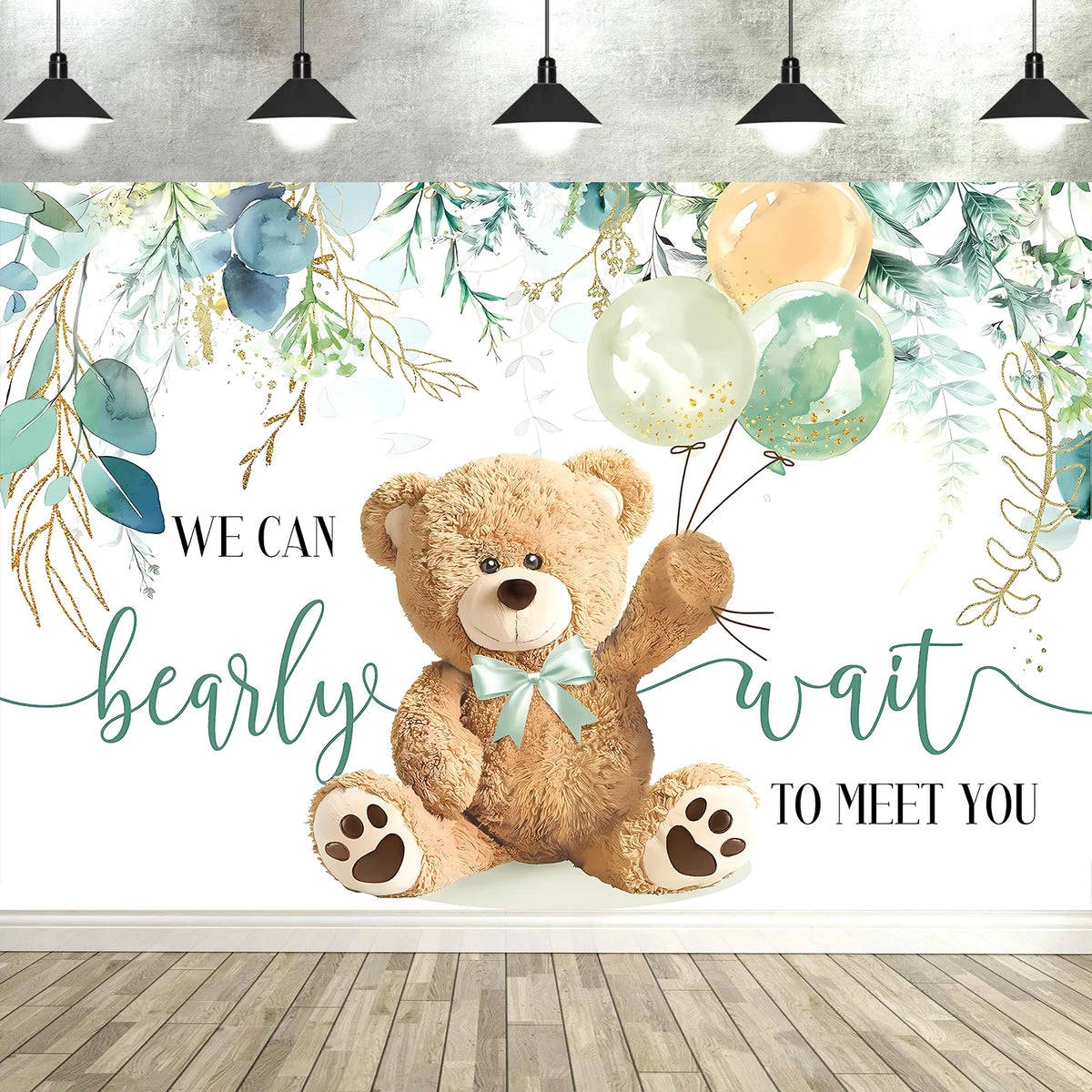 A photo backdrop featuring a cute cartoon teddy bear surrounded by watercolor greenery and light balloons for a baby shower.