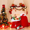 Festive red velvet Santa Claus gift bags displayed on a fireplace mantel with Christmas decorations.
