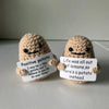Two handmade knitted plush dolls shaped like potatoes with handwritten messages