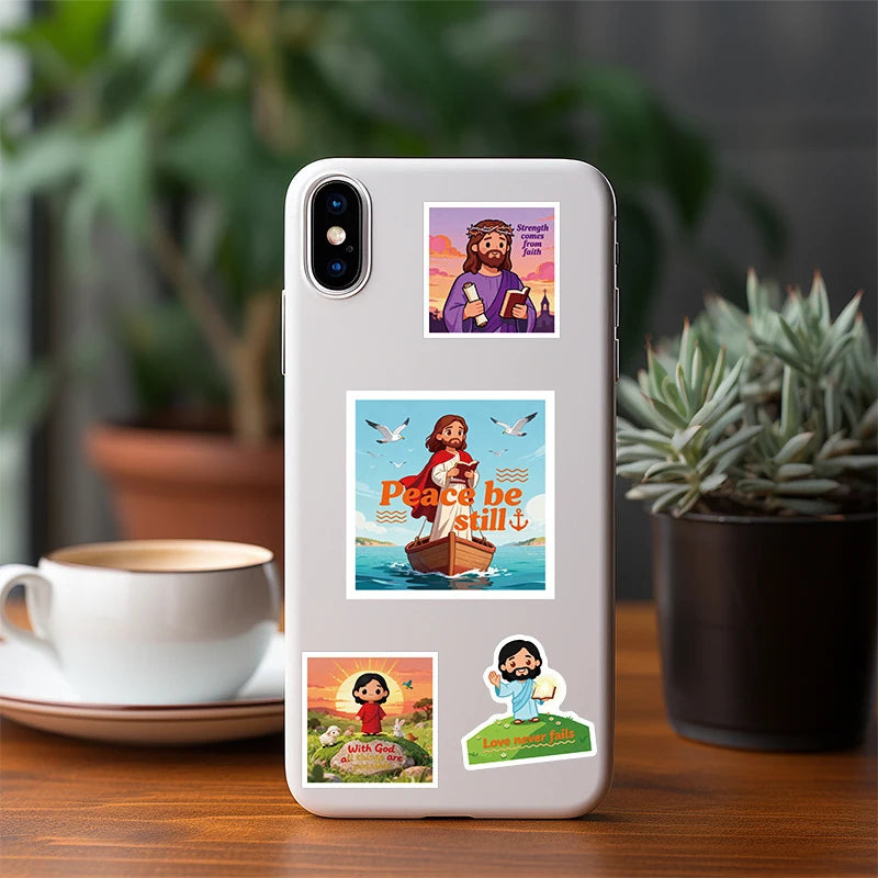 A white smartphone displays a set of Christian faith stickers featuring Jesus and peace themes.
