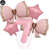 A set of pink bow disposable party tableware, including star-shaped decorations and a number seven balloon.