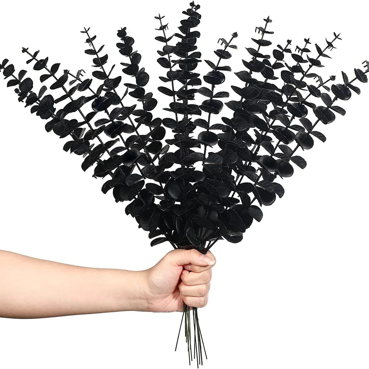 A hand is holding a bunch of artificial eucalyptus leaves for home and party decor.