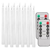 A collection of white flameless LED taper candles and a remote control with timer functions.