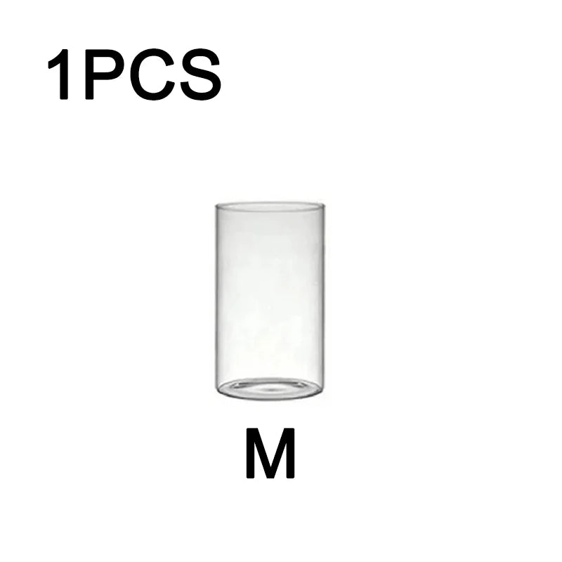 One clear glass candle holder with a cylindrical shape.