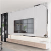 Modern home decor featuring a large acrylic mirror strip wall panel above a wooden floating shelf and a television.